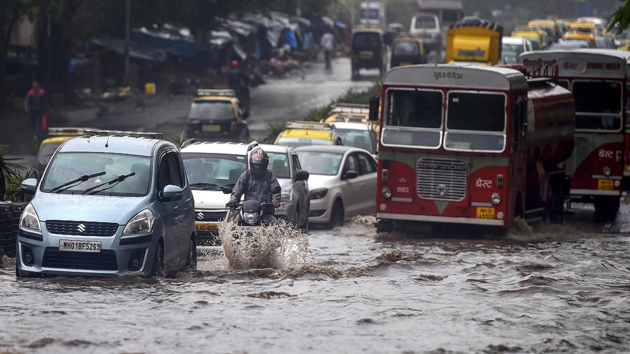 Vehicles wade through water-logged roads during heavy rains in Mumbai. (Image: PTI)