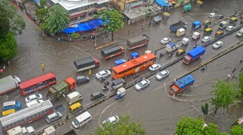 Vehicles wade through water-logged street at King Circle after heavy rains in Mumbai. (Image: PTI)