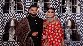 India's cricket team captain Virat Kohli (L) and his wife, Bollywood actress Anushka Sharma, pose during a photo oppurtunity at their wedding reception in New Delhi, India December 21, 2017. REUTERS/Adnan Abidi - RC130DC31220