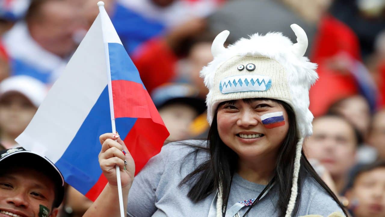 A fan waves a Russian flag at the opening ceremony. (Image: Reuters)