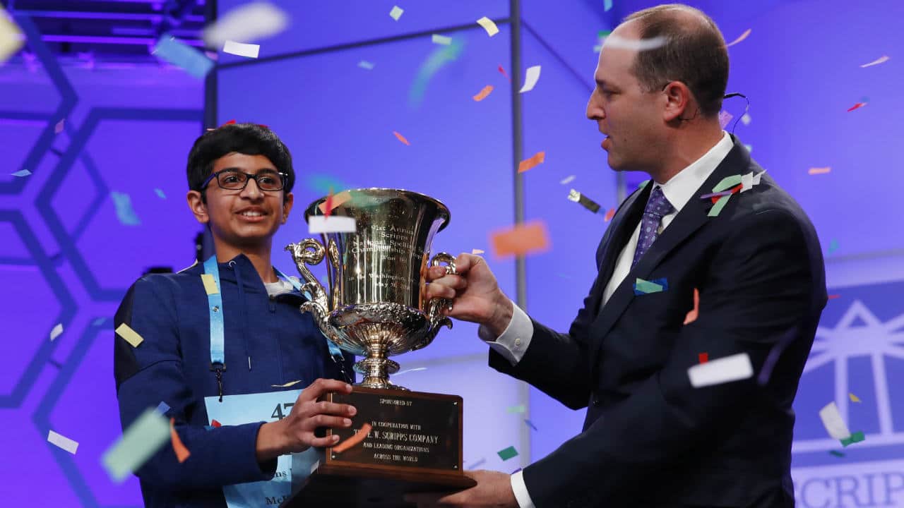 Karthik Nemmani holds his trophy with President and CEO of the E.W. Scripps Company, Adam Symson. (Photo: AP)