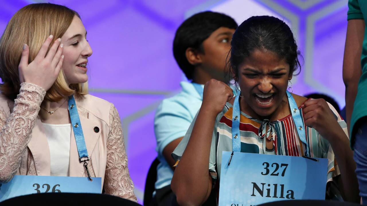 Phoebe Smith, 12, from Pennsylvania (L) and Nilla Rajan, 13, from Ohio celebrate as a competitor spells her word correctly. (Photo: AP)