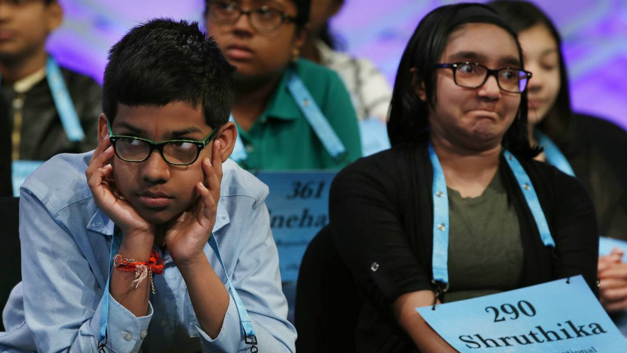 Navneeth Murali, 12, and Shruthika Padhy, 12, react during competition in the spelling contest. (Photo: AP) 