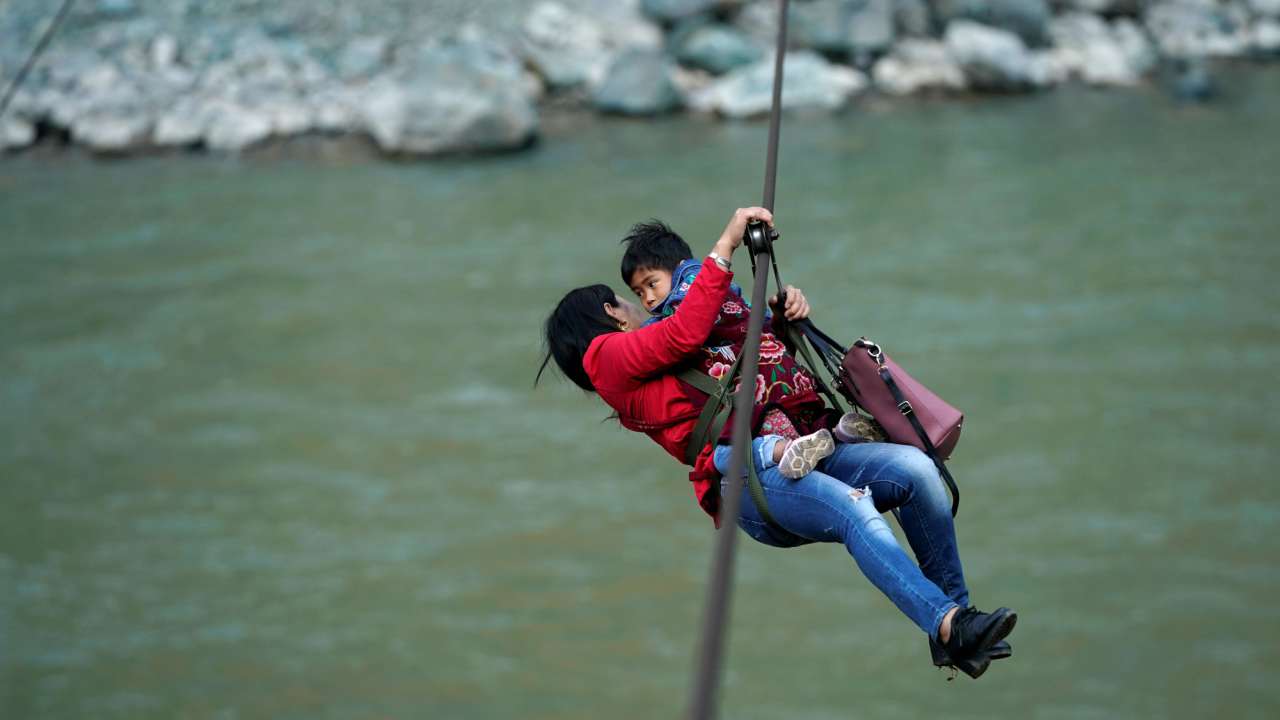 With no roads or bridges, mountain dwellers zipline their way over risky rapids in Chinese villages