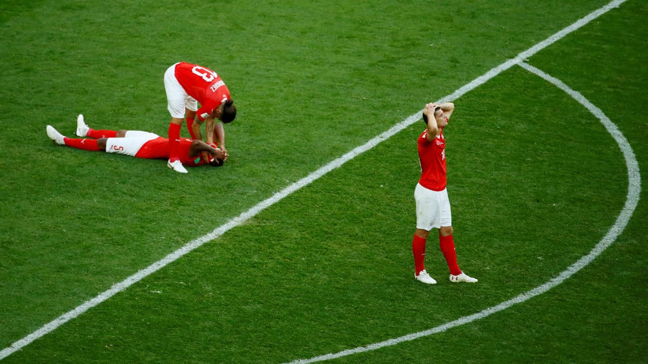 The Swiss players look dejected after the final whistle. (Image: Reuters)