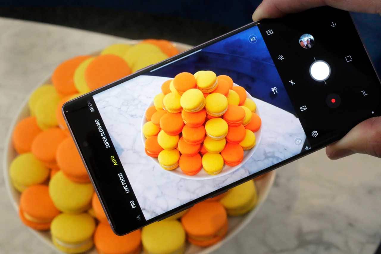 Samsung Galaxy Note 9 Camera | The camera in the Note 9 will use artificial intelligence to detect what's in a scene — whether that's food, flowers or a sunset — to automatically tweak images to make them pop. It's much like applying filters with an app, except that the phone will do this itself, much the way Google's Pixel phones already do. The camera will also offer a warning if someone blinked in a shot, or if the image is blurry. (Image: AP) Samsung Galaxy Note 9 Camera | The camera in the Note 9 will use artificial intelligence to detect what's in a scene — whether that's food, flowers or a sunset — to automatically tweak images to make them pop. It's much like applying filters with an app, except that the phone will do this itself, much the way Google's Pixel phones already do. The camera will also offer a warning if someone blinked in a shot, or if the image is blurry. (Image: AP)