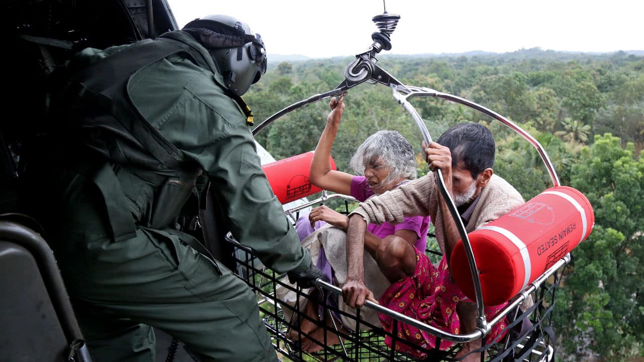 People are airlifted by Indian Navy personnel during a rescue operation at a flooded area in the southern state. (Image: Reuters)