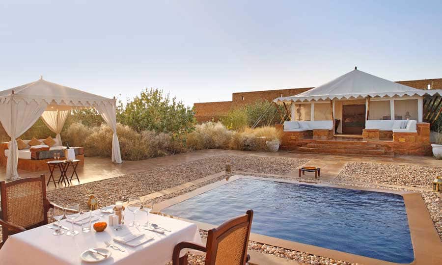 The mention of the word “camping” certainly brings back memories of trekking, putting up makeshift tents, snoozing within sleeping bags and spending nights in front of a bonfire. Camping reconnects us with nature’s ethereal beauty. But, imagine if we add a dash of luxury to it?  That’s what “glamping” is all about.  It’s similar to camping, albeit with luxurious environs and modern interiors, where you will spend time with nature without getting your hands dirty, or worrying about bugs and freezing temperatures. If you are the glamping kinds, here are four luxurious glamping sites in India that will enthral you: