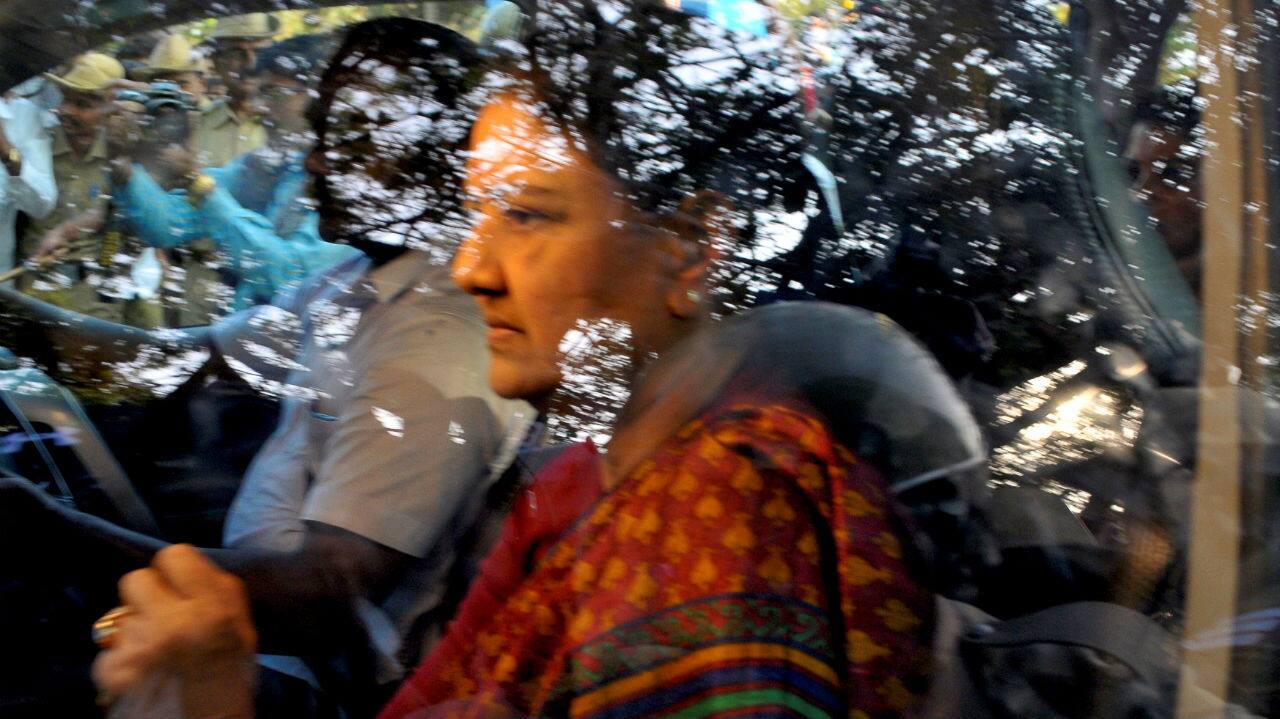 VK Sasikala, then General Secretary of AIADMK, sits inside her car as she arrives to surrender at the central jail in Bengaluru, Karnataka on February 15, 2017. (Image: Reuters)