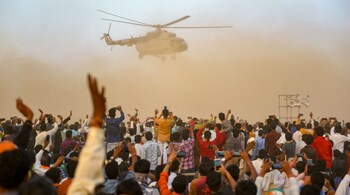 BJP supporters wave at Prime Minister Narendra Modi's chopper during a poll rally, in Mandsaur, Madhya Pradesh on November 24, 2018. (Image: PTI)