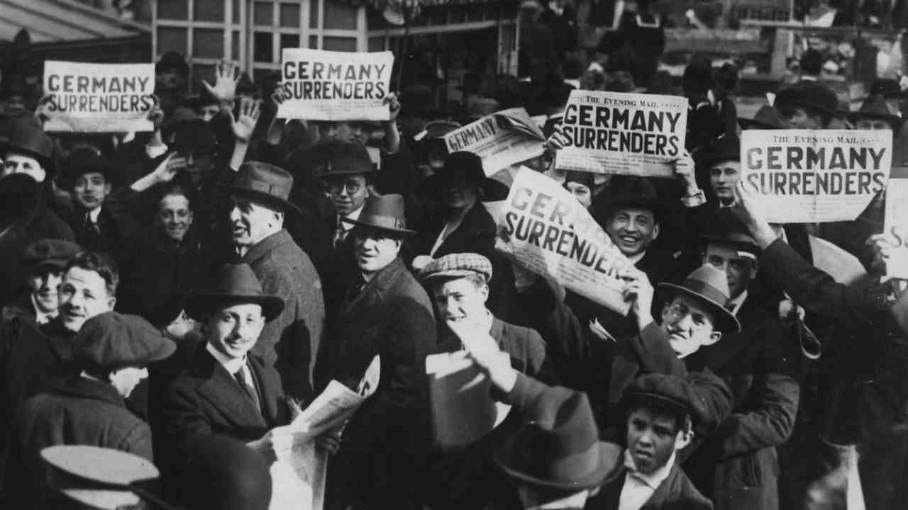 Pictured: People gathered at Times Square, holding copies of newspapers with a headline about the signing of the Armistice to end the war. (Image: Reuters) Pictured: People gathered at Times Square, holding copies of newspapers with a headline about the signing of the Armistice to end the war. (Image: Reuters)