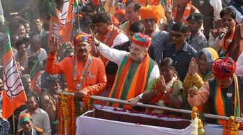 BJP President Amit Shah waves to his party supporters during an election campaign ahead of the state Assembly elections, in Ajmer