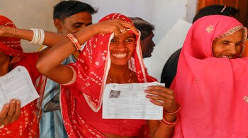 Ajmer: A voter smiles as she shows identity card during the state Assembly elections, at a polling station in Ajmer, Friday, Dec.07, 2018. (PTI Photo)(PTI12_7_2018_000059B)