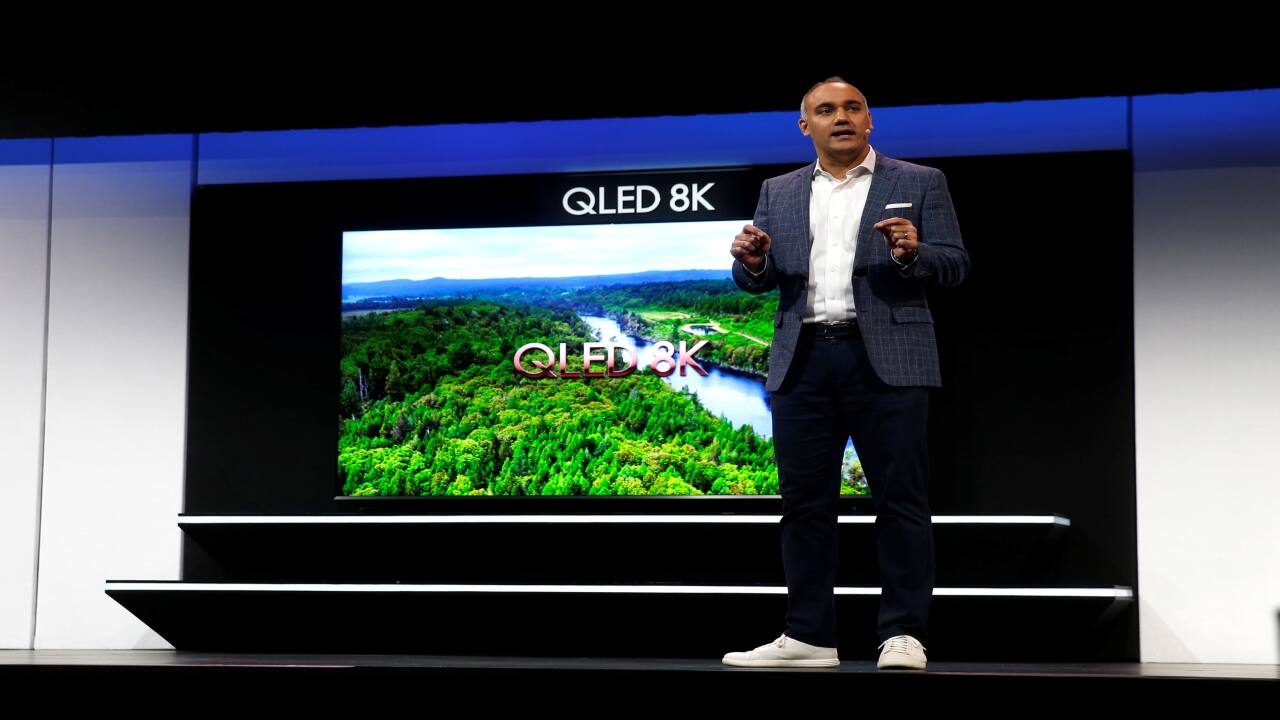 Dave Das, Senior Vice-President of consumer electronics product marketing at Samsung Electronics America, speaks by a 98-inch, QLED 8K smart television during a news conference at CES 2019. (Image: Reuters)