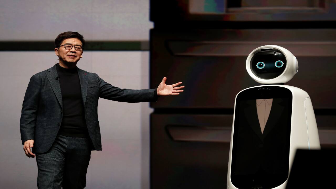 IP Park, President and Chief Technical Officer for LG Electronics, gestures toward a LG CLOi robot during a keynote address at CES 2019. (Image: Reuters)