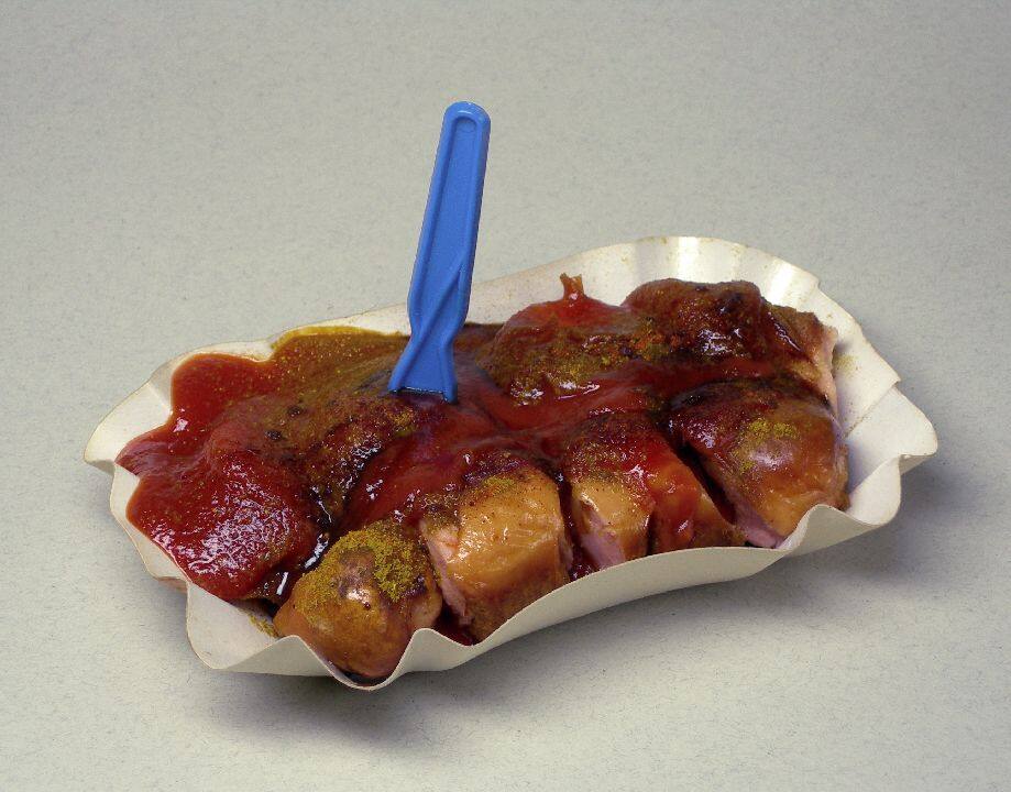Answer: Currywurst: The invention of currywurst is attributed to Herta Heuwer in Berlin in 1949, after she obtained ketchup (or possibly Worcestershire sauce) and curry powder from British soldiers in Germany. (Image source: Wikipedia)