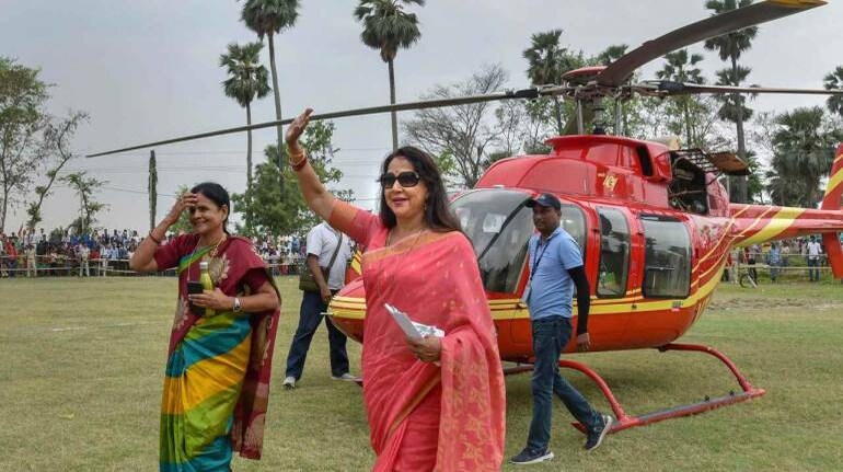 Bollywood actor and BJP Lok Sabha candidate Hema Malini waves at party supporters during an election rally at Kesariya, in East Champaran district. (Image: PTI)