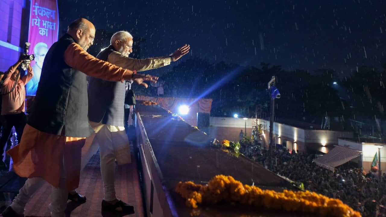 PM Modi and BJP President Amit Shah waving to party workers at BJP headquarters in New Delhi. (Image: Reuters)