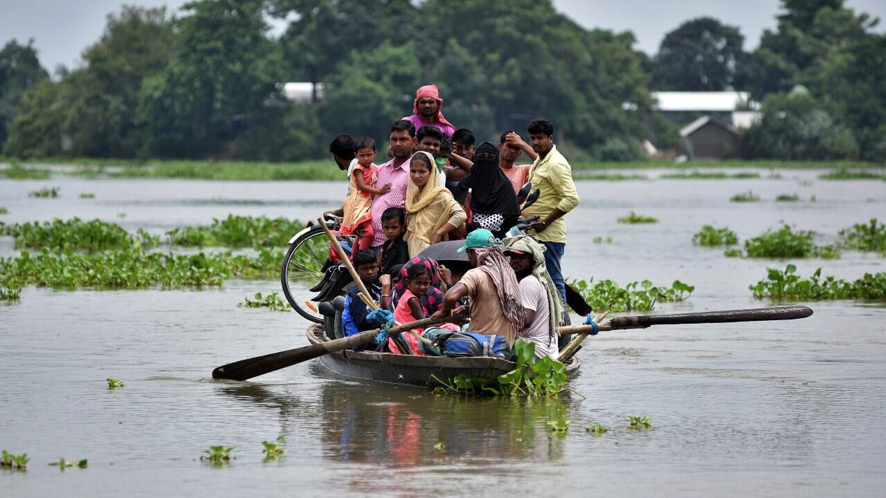 Around 43 lakh people have been affected by these floods. Seen here is affected villagers taking shelter on the roof of their submerged houses in Katahguri village along the river Brahmaputra, east of Gauhati. (Image: Reuters)