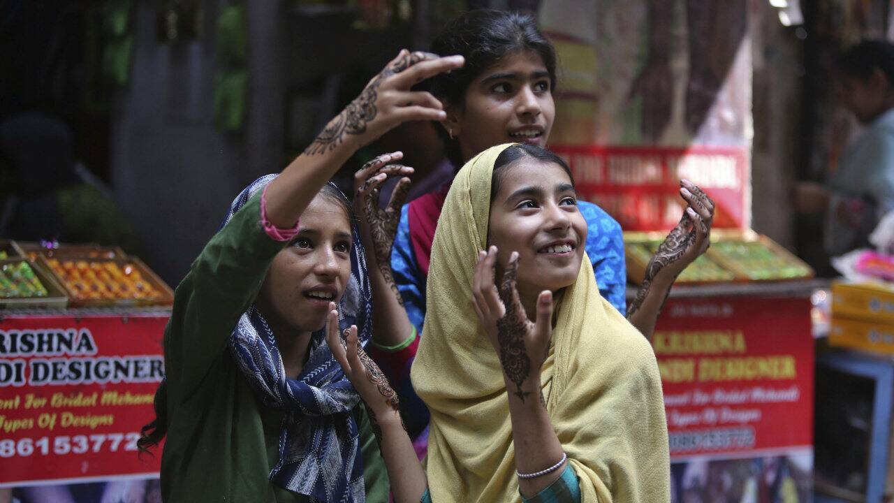 Girls gesture after getting henna decorations on their hands on the eve of Eid al Adha, in Jammu, Jammu and Kashmir. (Image: AP) Girls gesture after getting henna decorations on their hands on the eve of Eid al Adha, in Jammu, Jammu and Kashmir. (Image: AP)