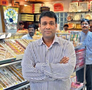 Q7. He spent his initial years in Bangalore before moving to Hyderabad. He started his first shop in Himayatnagar in 1993 with Rs 30,000 in seed capital and blessings and expertise from his mother. Identify him Q7. He spent his initial years in Bangalore before moving to Hyderabad. He started his first shop in Himayatnagar in 1993 with Rs 30,000 in seed capital and blessings and expertise from his mother. Identify him