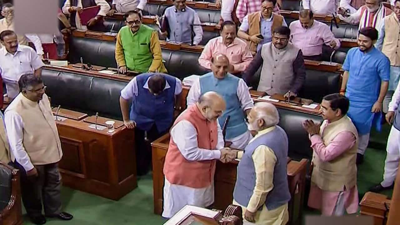 Home Minister Amit Shah is seen with PM Modi after a Bill to bifurcate J&K was passed in Lok Sabha. (Image: PTI)