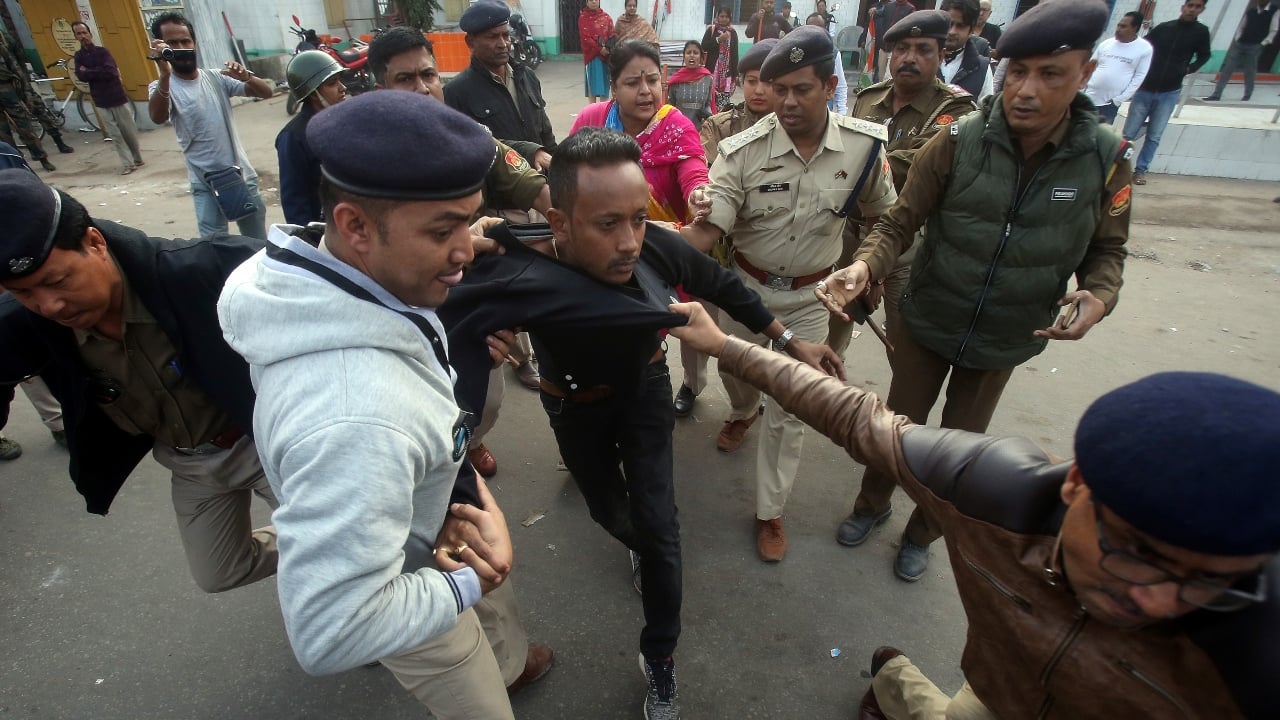 Policemen detain a demonstrator during a protest after India's parliament passed Citizenship Amendment Bill (CAB), in Agartala, Tripura. The Northeast has been on a boil since the passage of the Bill by both the House of Parliament. Curfew was imposed and internet services snapped in various parts of Tripura and Assam. (Image: Reuters)