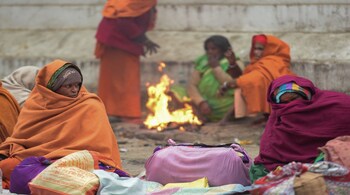 New Delhi: People warm themselves around a bonfire on a cold wintry morning, in New Delhi. (PTI Photo/Vijay Verma) (PTI12_26_2019_000082B)