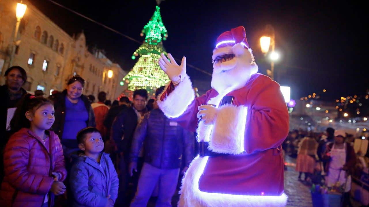 A man dressed as Santa Claus waves at the San Francisco square in La Paz, Bolivia (Image: Reuters)