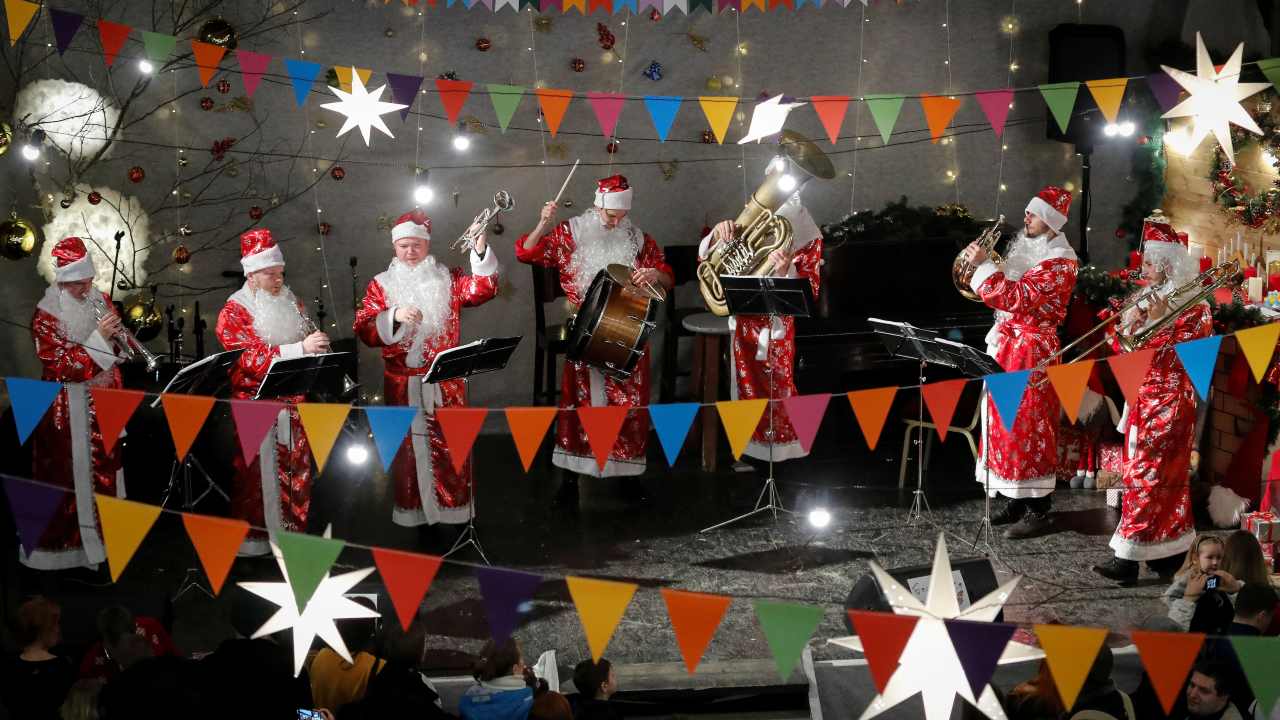 Musicians dressed in Santa Claus costumes perform at New Year Fair in St. Anne's Lutheran Church in Saint Petersburg, Russia (Image: Reuters)