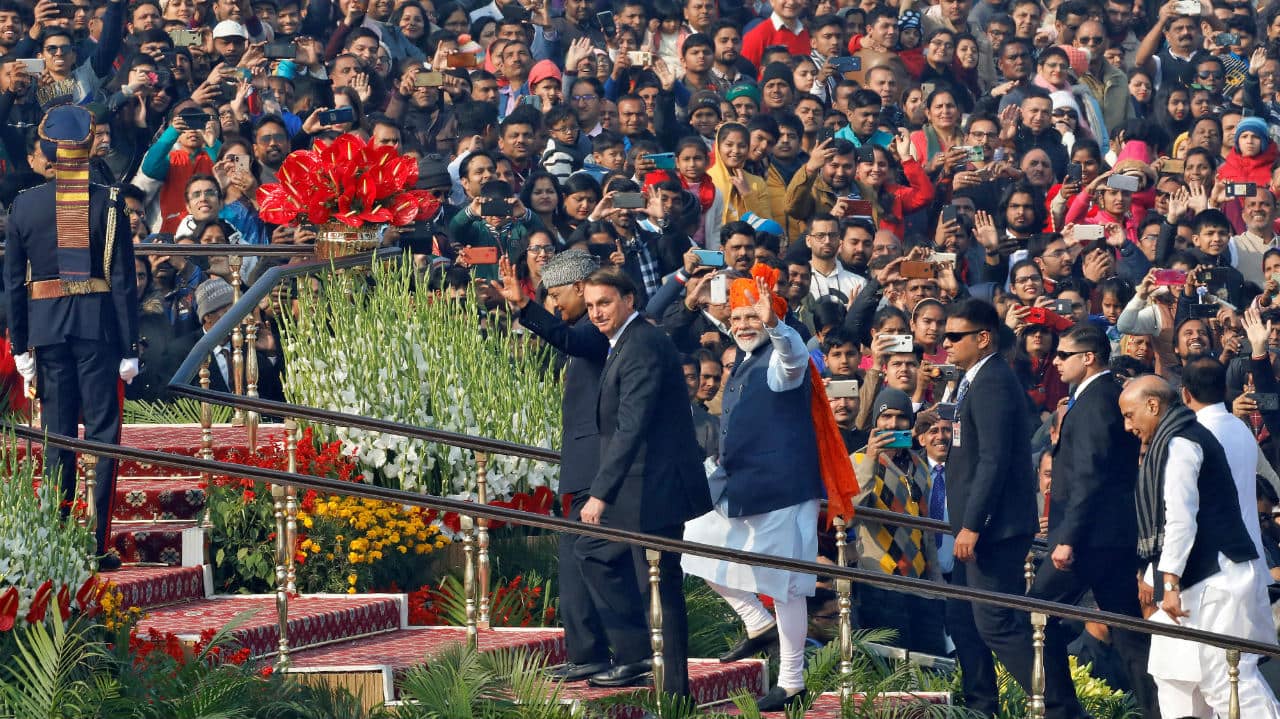 Prime Minister Narendra Modi waves next to Brazilian President Jair Bolsonaro and Indian President Ram Nath Kovind as they arrive for the Republic Day parade in New Delhi. (Image: Reuters)
