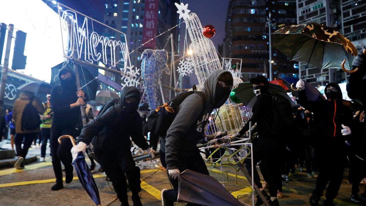 Anti-government protesters tear down Christmas and New Year decorations during a demonstration on New Year's Eve outside Mong Kok police station in Hong Kong, China. (Image: Reuters) Anti-government protesters tear down Christmas and New Year decorations during a demonstration on New Year's Eve outside Mong Kok police station in Hong Kong, China. (Image: Reuters)