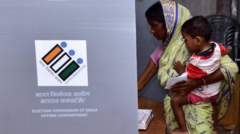 https://images.moneycontrol.com/static-mcnews/2020/02/A-woman-holds-a-child-as-she-casts-her-vote-at-a-polling-station-in-Assam-during-the-2019-Lok-Sabha-election.-Image-Reuters-770x433.jpg?impolicy=website&width=770&height=431