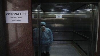 A lift operator stands inside a dedicated lift for people suspected to be infected with the new coronavirus at the Government Gandhi Hospital in Hyderabad, India, March 2, 2020. (AP Photo/Mahesh Kumar A.)
