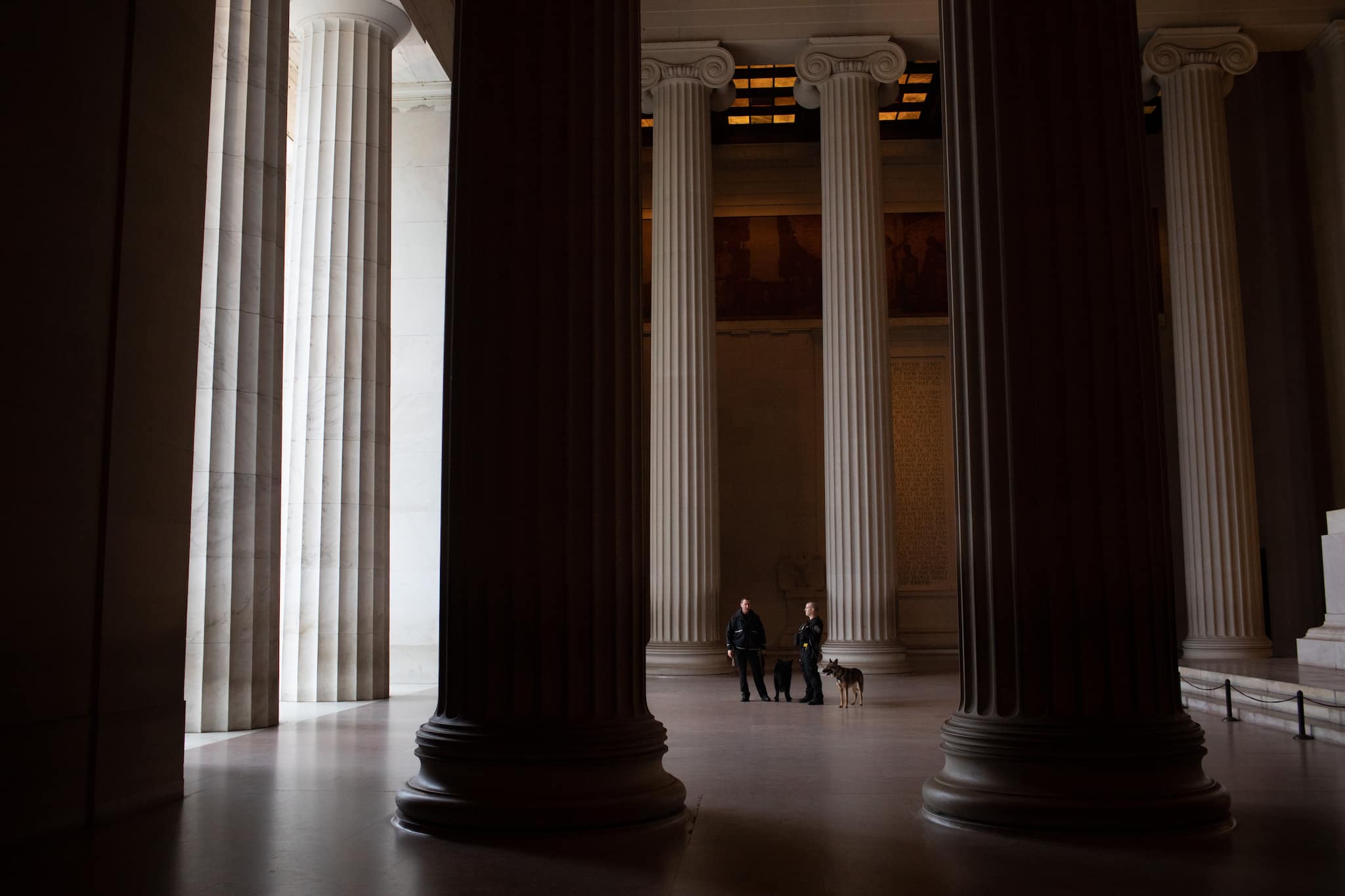 U.S. Park Police and their dogs stand on duty at a nearly empty Lincoln Memorial in Washington, D.C. on Thursday, March 19, 2020. (Alyssa Schukar/The New York Times)