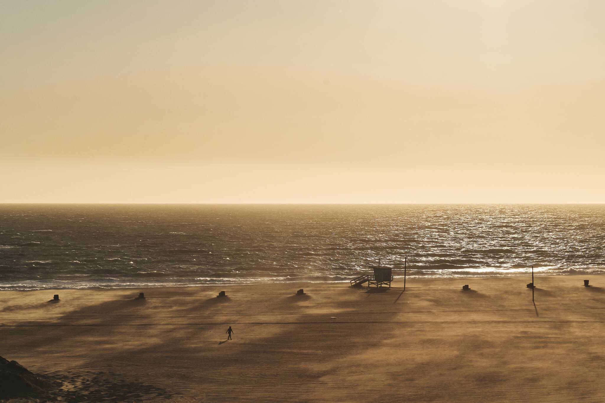 An unchanging ocean, a barely recognizable beach in Santa Monica, Los Angeles, March 18, 2020. (Philip Cheung/The New York Times)