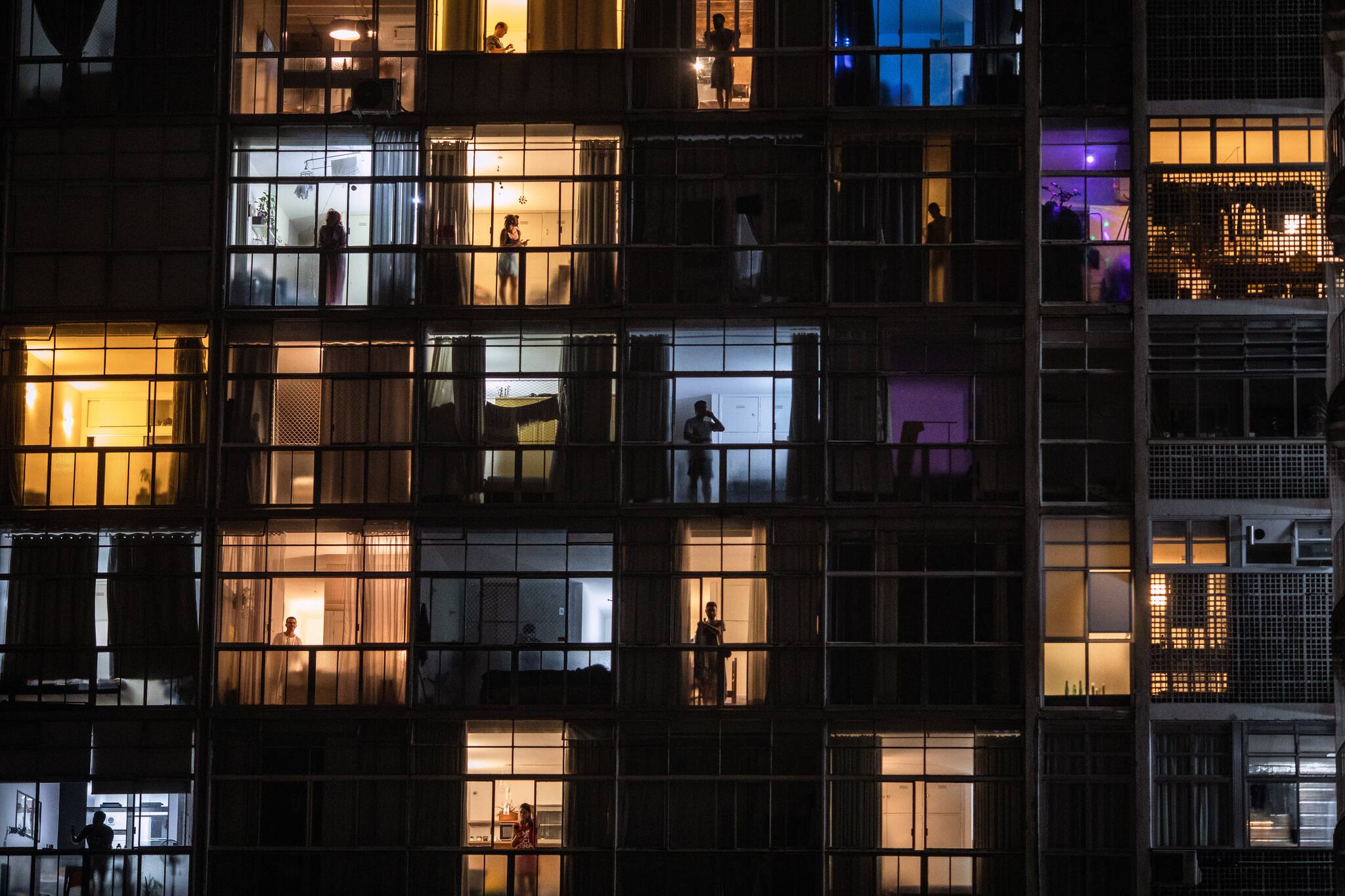 Living quarters are lit up in São Paulo, Brazil, on Wednesday, March 19, 2020, where many people are staying home because of the coronavirus. (Victor Moriyama/The New York Times)