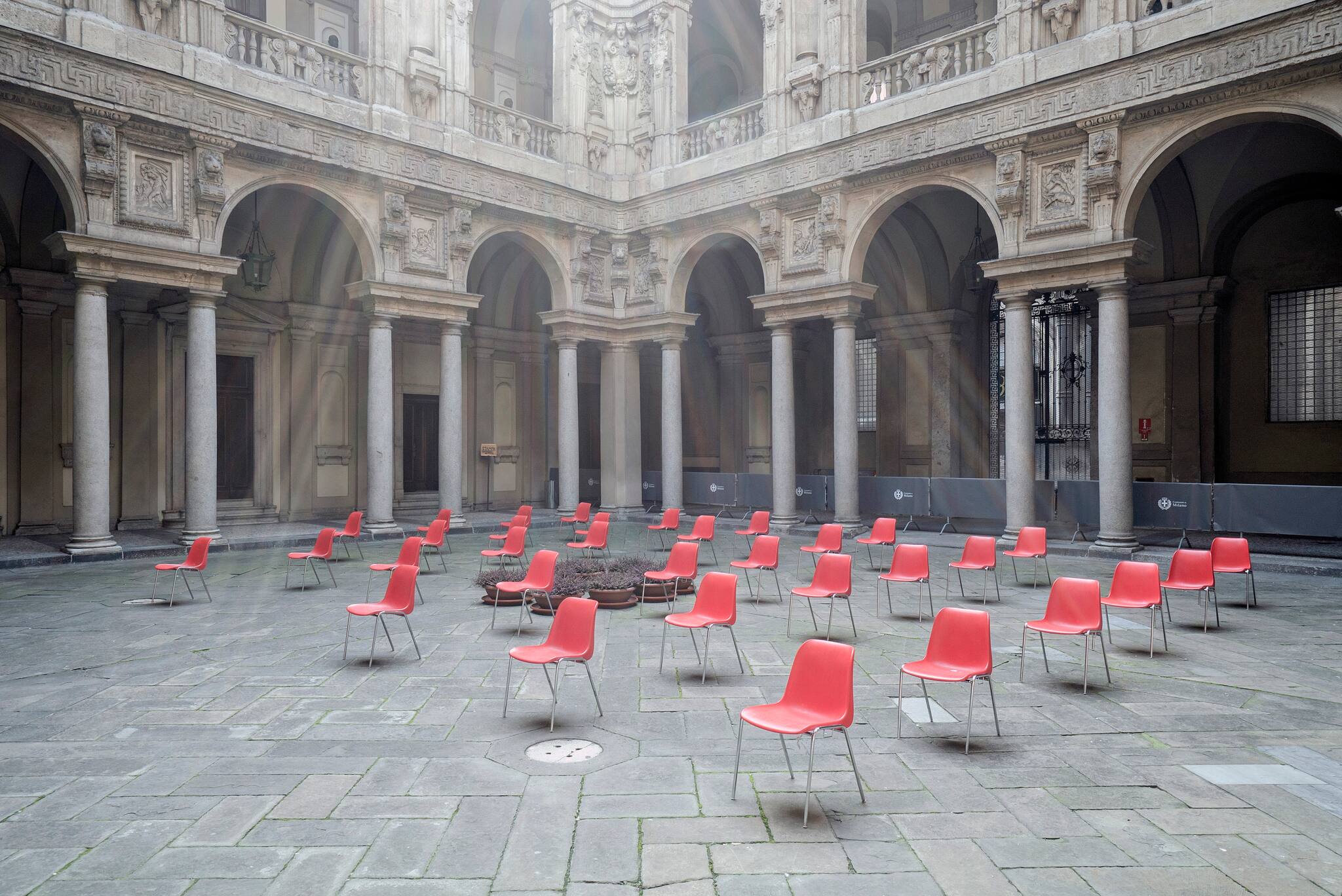 At Palazzo Marino in Milan, headquarters of the municipality of the city, chairs are placed outdoors and at a safe distance before a meeting, March 20, 2020. (Alessandro Grassani/The New York Times)