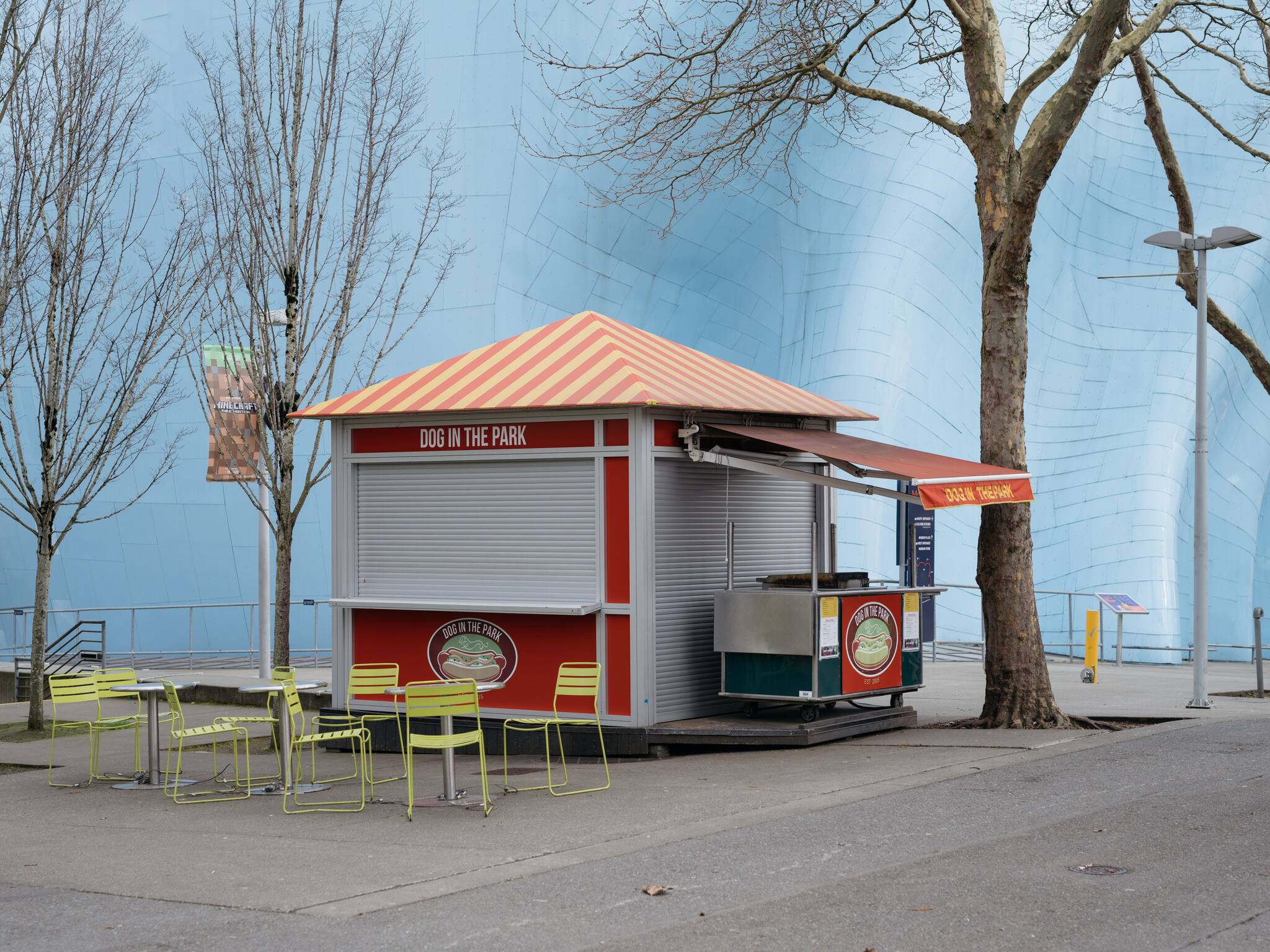 A closed hotdog stand nestled under a closed Space Needle and Museum of Pop Culture in Seattle, March 14, 2020.  (Grant Hindsley/The New York Times)