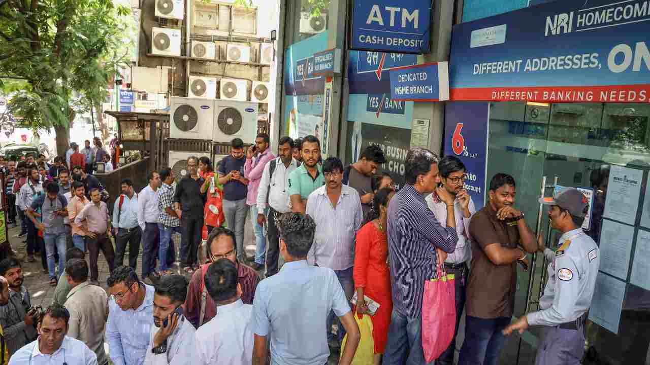 In pics: Customers of Yes Bank line up outside ATMs for cash