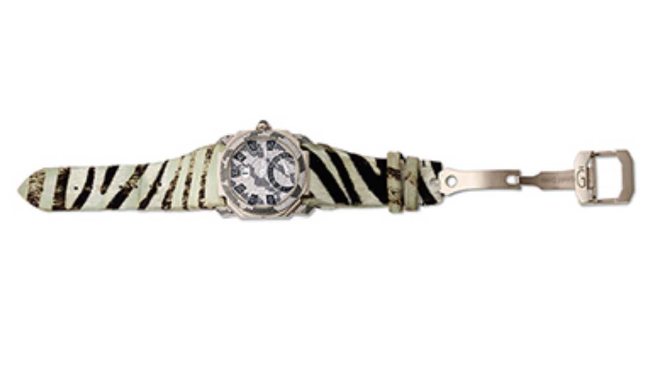 GÉRALD GENTA: &#96;OCTO BI RETRO&#96; WHITE GOLD AND DIAMOND WRISTWATCH Sold for Rs 10.86 lakh An unusual 18K gold and diamond wristwatch with similarly matched zebra style straps has a jump-hour dial with Arabic numerals as minutes and pavé-set with diamonds. 