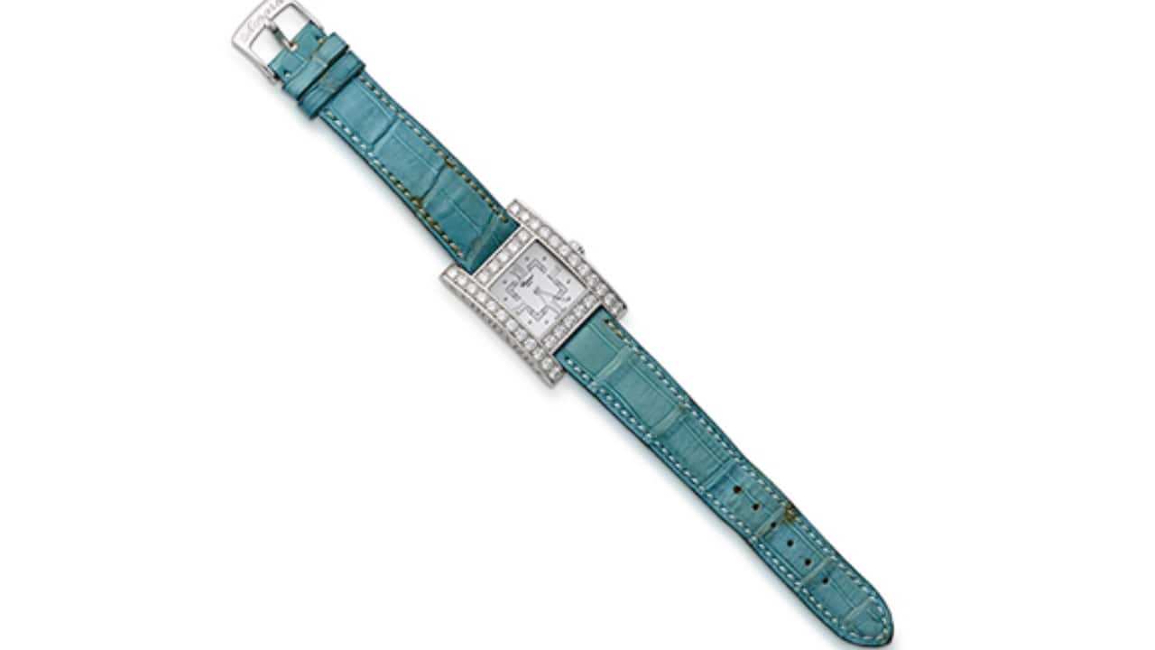 CHOPARD: &#96;YOUR HOUR&#96; WHITE GOLD AND DIAMOND WRISTWATCH Sold for Rs 5.2 lakh An 18K white gold and diamond wristwatch with a mother-of-pearl dial, diamond-set case bezel, stick hands, Roman numerals as quarter markers and a 4-jewels quartz movement.