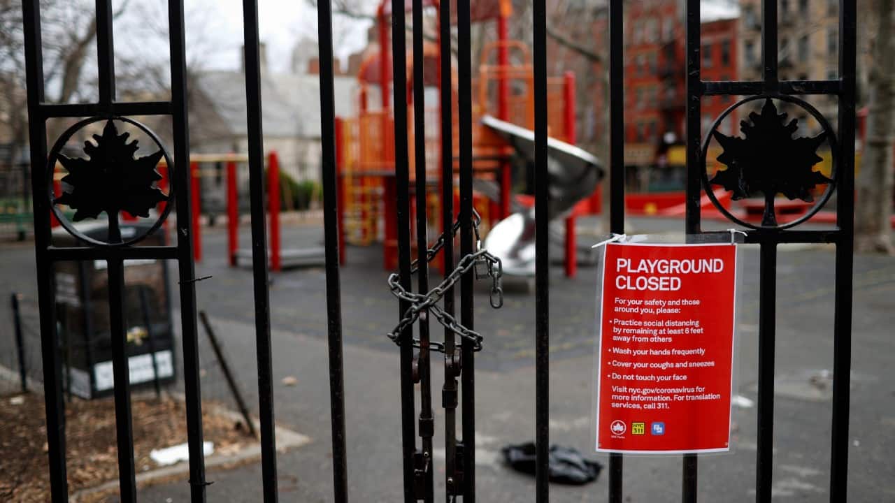 The swing chains are knotted together to keep them from being used and other playground equipment lie lonely and unused behind the caution tape and signs announcing closure. (Image: Reuters)