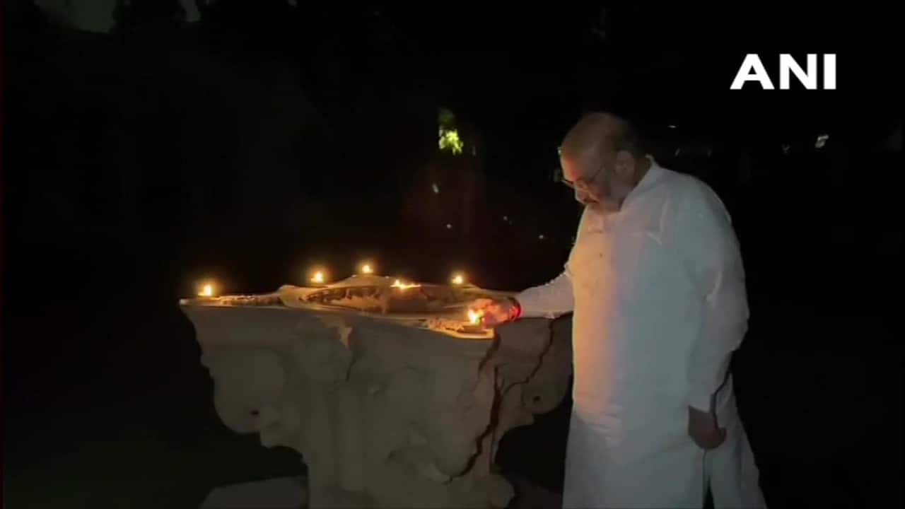 Home Minister Amit Shah lighting earthen lamps after turning off all the lights at his residence. (Image: ANI)