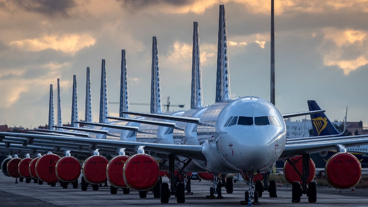 Vueling Airlines planes sit parked in a line at the Seville, Spain airport on Saturday, March 21, 2020, idled due to the COVID-19 coronavirus outbreak. (Image: AP)