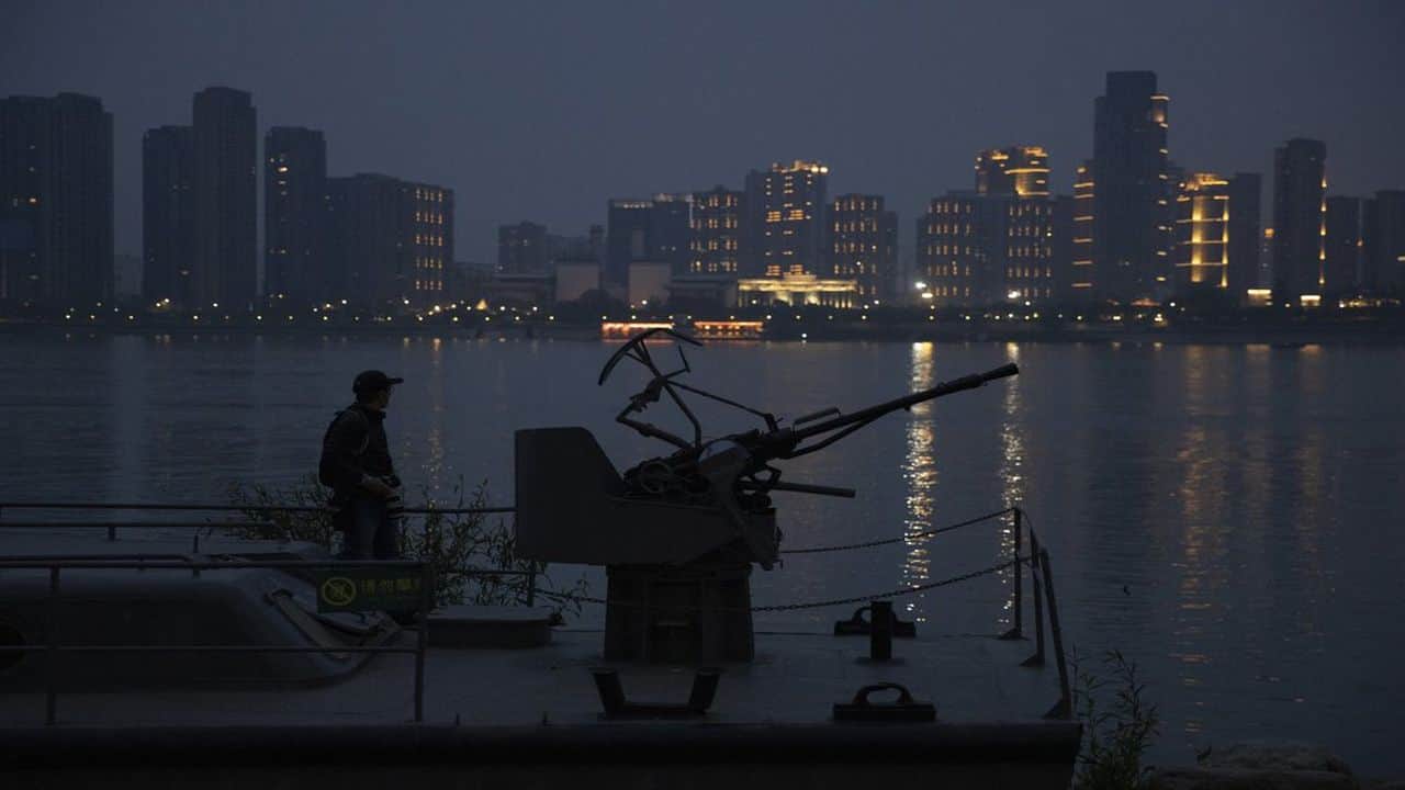 A resident looks out from onboard a gunboat relic displayed along the Yangtze River in Wuhan in central China's Hubei province. (AP)