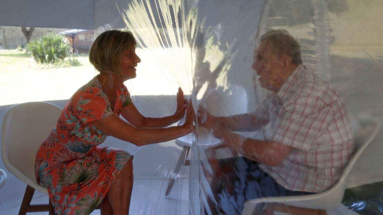 Nathalie interacts with her husband Joseph behind a transparent plastic sheet inside a bubble room installed to visit residents in the garden of the Fondation Shadet Vercoustre retirement home (Ehpad - Housing Establishment for Dependant Elderly People) in Bourbourg near Dunkirk, amid the coronavirus outbreak in France, May 25, 2020. (Image: Reuters) Nathalie interacts with her husband Joseph behind a transparent plastic sheet inside a bubble room installed to visit residents in the garden of the Fondation Shadet Vercoustre retirement home (Ehpad - Housing Establishment for Dependant Elderly People) in Bourbourg near Dunkirk, amid the coronavirus outbreak in France, May 25, 2020. (Image: Reuters)