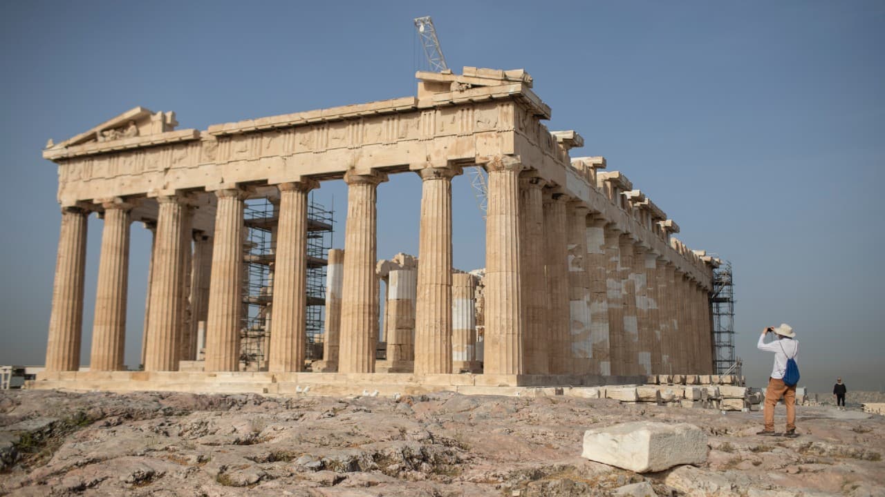 A man takes a picture next the ancient Parthenon temple at the Acropolis hill of Athens. (Image: AP)