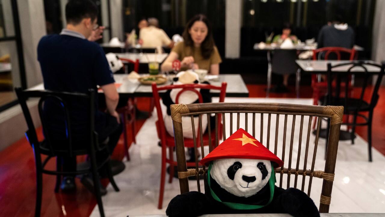 People have dinner as they sit next to stuffed panda dolls, used as a part of social distancing measures, at the reopened Maison Saigon restaurant in Bangkok, Thailand, on May 13. (Image: Reuters) People have dinner as they sit next to stuffed panda dolls, used as a part of social distancing measures, at the reopened Maison Saigon restaurant in Bangkok, Thailand, on May 13. (Image: Reuters)