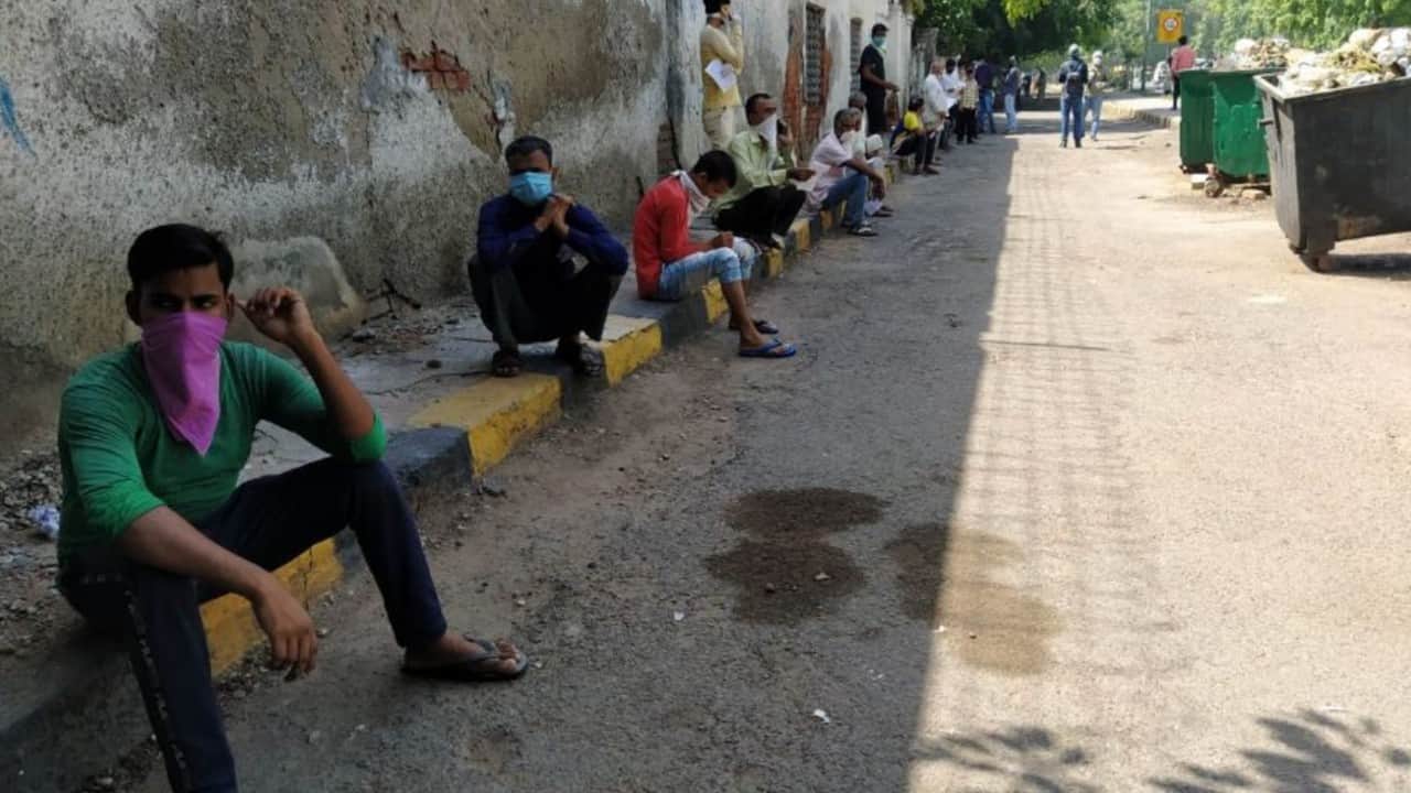 People filing forms while waiting for their turn to buy railway ticket. (Image: News18)